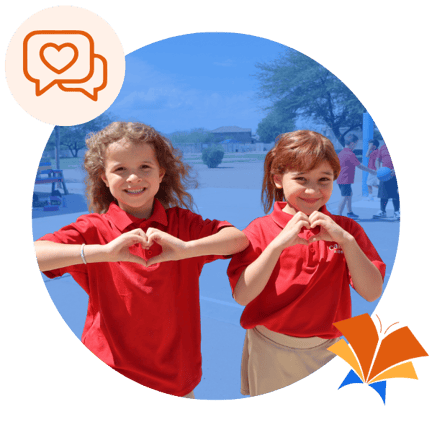 Two students making heart sign