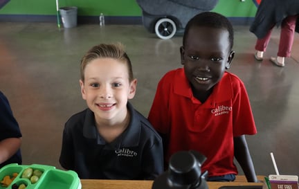 two students smiling at the lunch table
